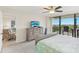 Relaxing bedroom with a ceiling fan, TV, and balcony access with outdoor seating at 2700 Bayshore Blvd # 9404, Dunedin, FL 34698