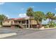 View of the community Cove Club with palm trees and well-maintained landscaping at 2700 Bayshore Blvd # 9404, Dunedin, FL 34698
