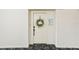 Charming front door with a decorative wreath and a welcoming sign at 2700 Bayshore Blvd # 9404, Dunedin, FL 34698
