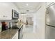 Galley kitchen with granite counters, stainless appliances and views of the dining area at 2700 Bayshore Blvd # 9404, Dunedin, FL 34698