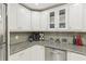 Kitchen features granite countertops, stainless steel dishwasher, and white cabinets at 2700 Bayshore Blvd # 9404, Dunedin, FL 34698