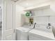 Functional laundry room with a washer, dryer, and shelving for storage at 2700 Bayshore Blvd # 9404, Dunedin, FL 34698