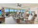 Bright living room with plush seating, ceiling fan, and balcony with scenic views at 2700 Bayshore Blvd # 9404, Dunedin, FL 34698