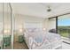 Main bedroom with a ceiling fan, large windows, and access to the balcony at 2700 Bayshore Blvd # 9404, Dunedin, FL 34698