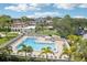 Inviting swimming pool in a condo community with palm trees, lounge chairs, and clear blue water at 2700 Bayshore Blvd # 9404, Dunedin, FL 34698