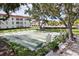 Enjoy the outdoors with shuffleboard courts surrounded by trees in a condo community at 2700 Bayshore Blvd # 9404, Dunedin, FL 34698