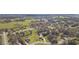 Expansive aerial view of the property showcasing lush green surroundings and a well-maintained lawn in a serene neighborhood at 27941 Austin Woods Dr, Dade City, FL 33525