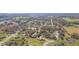 Aerial view of the property in a quiet residential neighborhood surrounded by lush greenery at 27941 Austin Woods Dr, Dade City, FL 33525