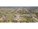 Aerial shot of a home in a rural neighborhood with verdant land and pond, creating a serene setting at 27941 Austin Woods Dr, Dade City, FL 33525