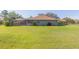 Backyard with an outdoor living space, lush greenery, and a private setting for relaxing at 27941 Austin Woods Dr, Dade City, FL 33525