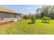 Spacious backyard featuring lush greenery, and generator perfect for enjoying outdoor living at 27941 Austin Woods Dr, Dade City, FL 33525