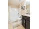 Well-lit bathroom featuring a shower-tub combo with stylish tile and a modern vanity at 27941 Austin Woods Dr, Dade City, FL 33525