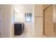 Bathroom featuring a vanity with granite countertop, and a tiled shower with glass doors at 27941 Austin Woods Dr, Dade City, FL 33525