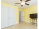 Bedroom with a ceiling fan, double closets, tile floor and a television at 27941 Austin Woods Dr, Dade City, FL 33525