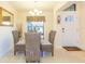 Charming dining area with seating for four near a window and the front door at 27941 Austin Woods Dr, Dade City, FL 33525