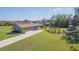Spacious home featuring a long driveway, a lush green lawn, and mature trees at 27941 Austin Woods Dr, Dade City, FL 33525