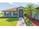 Welcoming front entrance featuring a screened entry and decorative landscaping at 27941 Austin Woods Dr, Dade City, FL 33525
