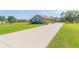 Charming single-story home featuring a spacious front yard, long driveway, and well-maintained landscaping at 27941 Austin Woods Dr, Dade City, FL 33525
