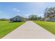Charming single-story home featuring a spacious front yard and a long driveway leading up to the house at 27941 Austin Woods Dr, Dade City, FL 33525