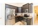 Modern kitchen featuring stainless steel appliances, granite countertops, and dark wood cabinetry at 27941 Austin Woods Dr, Dade City, FL 33525