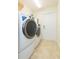 This laundry room features a modern washer and dryer, plus a white door at 27941 Austin Woods Dr, Dade City, FL 33525