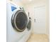Well-lit laundry room features modern washer and dryer at 27941 Austin Woods Dr, Dade City, FL 33525