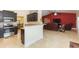Open-concept living room and kitchen area with stainless steel appliances and bar seating at 27941 Austin Woods Dr, Dade City, FL 33525