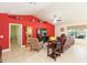 Spacious living room with a vaulted ceiling, tile floors, and a bright red accent wall at 27941 Austin Woods Dr, Dade City, FL 33525