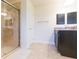 Main bathroom vanity, shower, tile floors and access to closet and toilet room at 27941 Austin Woods Dr, Dade City, FL 33525