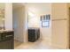 Main bathroom vanity with granite countertops, shower, tile floors and access to closet and toilet room at 27941 Austin Woods Dr, Dade City, FL 33525