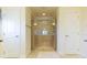 Clean main bathroom showcases a glass shower enclosure, tile floors, and dual closet doors at 27941 Austin Woods Dr, Dade City, FL 33525