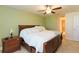 Cozy main bedroom features a ceiling fan, tile floors and adjacent main bathroom and walk-in closet at 27941 Austin Woods Dr, Dade City, FL 33525