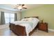 Spacious main bedroom features a large window, ceiling fan, and an ensuite bathroom and walk-in closet at 27941 Austin Woods Dr, Dade City, FL 33525