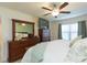 Comfortable main bedroom featuring a ceiling fan and plenty of storage at 27941 Austin Woods Dr, Dade City, FL 33525