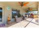 Covered outdoor patio with a built-in kitchen, seating, and stylish decor at 27941 Austin Woods Dr, Dade City, FL 33525