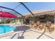 The home's screened-in pool and patio area with outdoor kitchen bar at 27941 Austin Woods Dr, Dade City, FL 33525