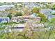 Aerial view showcasing the community layout with buildings, parking, and mature trees at 300 Promenade Dr # 106, Dunedin, FL 34698