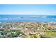 Stunning aerial view of a coastal community near the ocean with clear blue skies at 300 Promenade Dr # 106, Dunedin, FL 34698