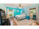 Coastal-themed bedroom with a ceiling fan, two windows, and a comfortable bed with starfish accents at 300 Promenade Dr # 106, Dunedin, FL 34698