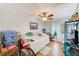 Bright bedroom with hardwood floors, large window, and ceiling fan at 300 Promenade Dr # 106, Dunedin, FL 34698