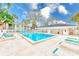 Refreshing community pool with ample lounge seating for relaxation and enjoyment at 300 Promenade Dr # 106, Dunedin, FL 34698