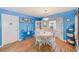 Bright dining room featuring a round table, white chairs, and a cozy bay window seating area at 300 Promenade Dr # 106, Dunedin, FL 34698