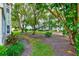 Scenic exterior view showcases lush landscaping and a peaceful setting at 300 Promenade Dr # 106, Dunedin, FL 34698