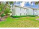 Manicured lawn surrounds the exterior of the home, complemented by neat shrubbery at 300 Promenade Dr # 106, Dunedin, FL 34698