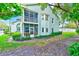 Well-maintained exterior of a two-story home with a screened porch, and bay window at 300 Promenade Dr # 106, Dunedin, FL 34698