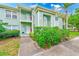 Charming two-story condo with well-maintained landscaping and a welcoming facade at 300 Promenade Dr # 106, Dunedin, FL 34698