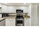 Well-equipped kitchen with modern appliances and ample counter space for cooking at 300 Promenade Dr # 106, Dunedin, FL 34698