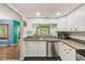 Efficient kitchen layout with stainless steel dishwasher and ample counter space at 300 Promenade Dr # 106, Dunedin, FL 34698