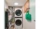 Efficient laundry room with stacked washer and dryer, maximizing space at 300 Promenade Dr # 106, Dunedin, FL 34698