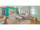 Comfortable living area with bright walls, plush seating, and a view of the outdoors at 300 Promenade Dr # 106, Dunedin, FL 34698